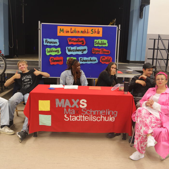 Schülergruppe an einem Stand mit dem Logo der Max Schmeling Stadtteilschule